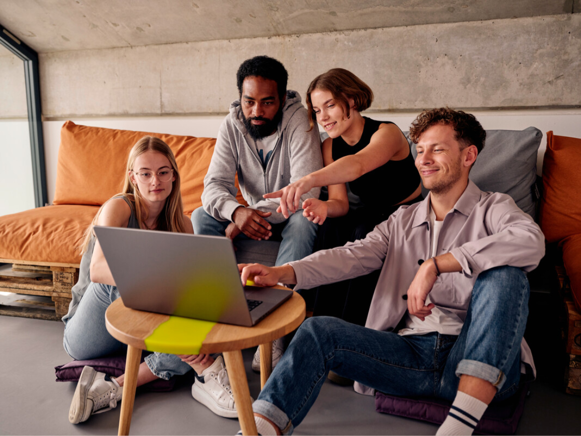 Young professionals on couch with laptops
